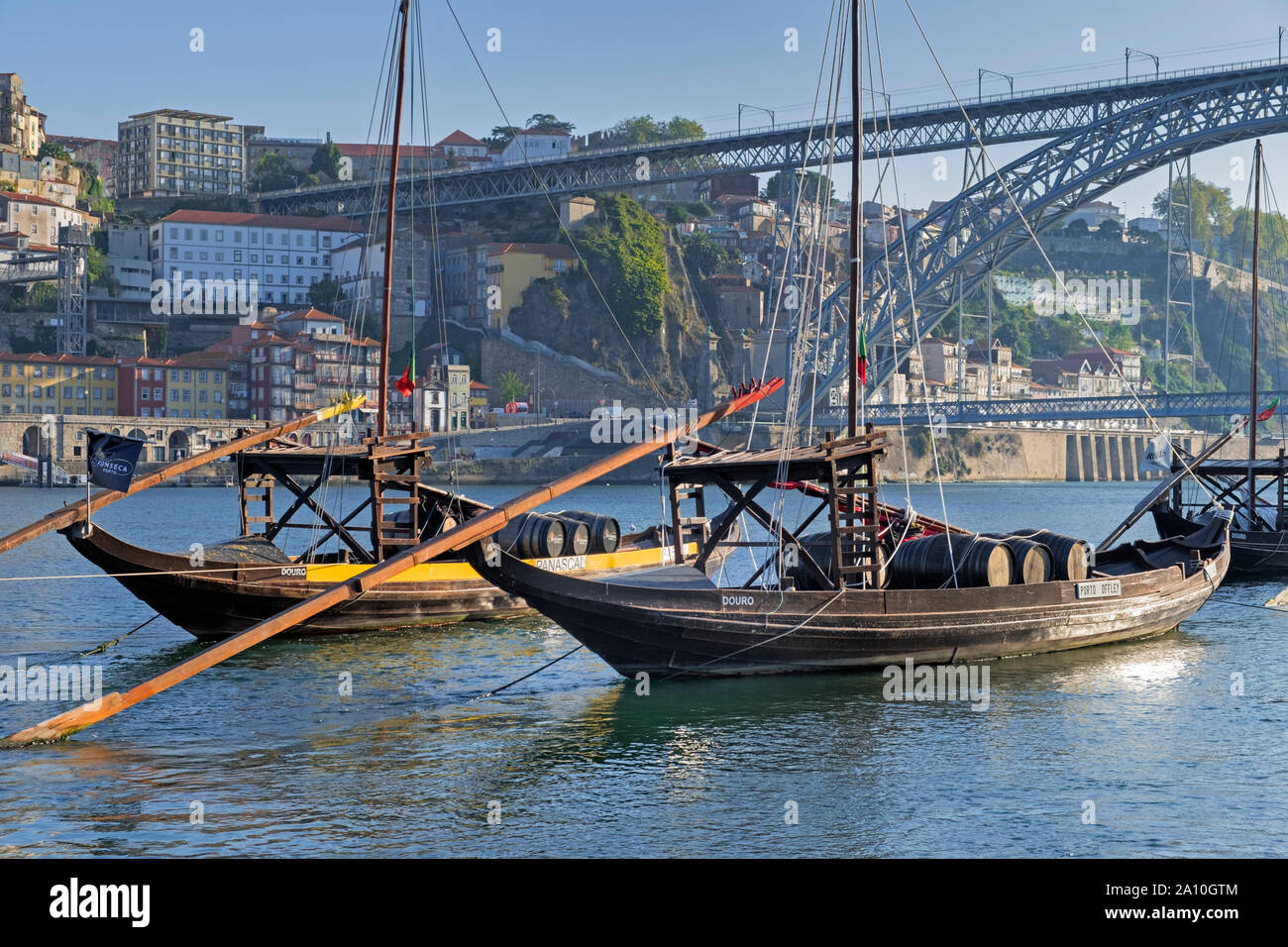 Port boats and Dom Luis I Bridge Douro River Porto Portugal Stock Photo