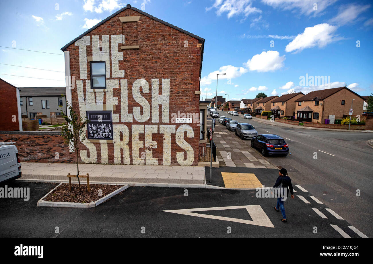 A mural with the wording 'The Welsh Streets' painted on the side of a house in Liverpool. The streets of the city have been transformed with bursts of colour as artists make their mark. Stock Photo