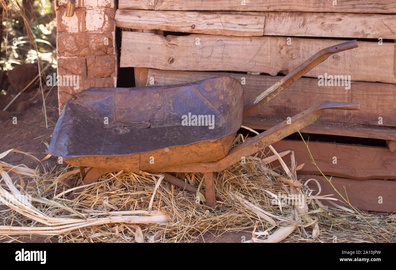 Old wheelbarrow on a farmyard, selective focuse Stock Photo