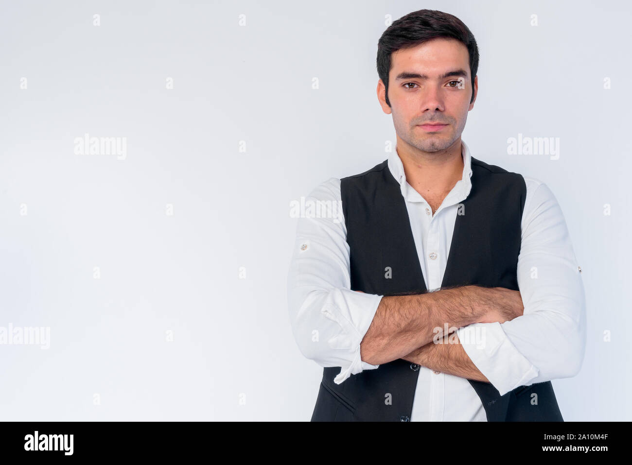 Portrait of young handsome Persian businessman with arms crossed Stock ...