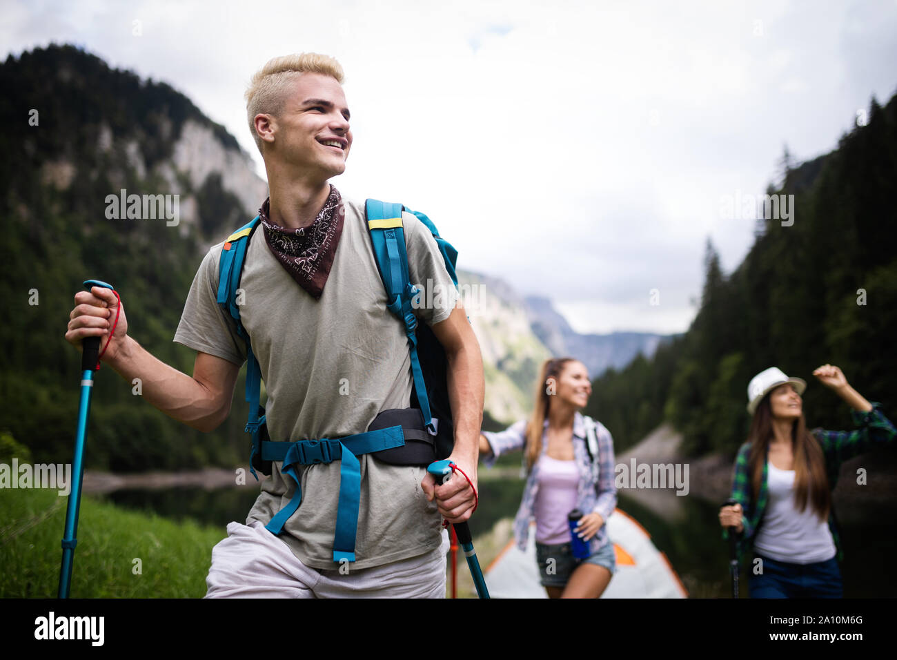 Group of friends hikers walking on a mountain at sunset Stock Photo - Alamy