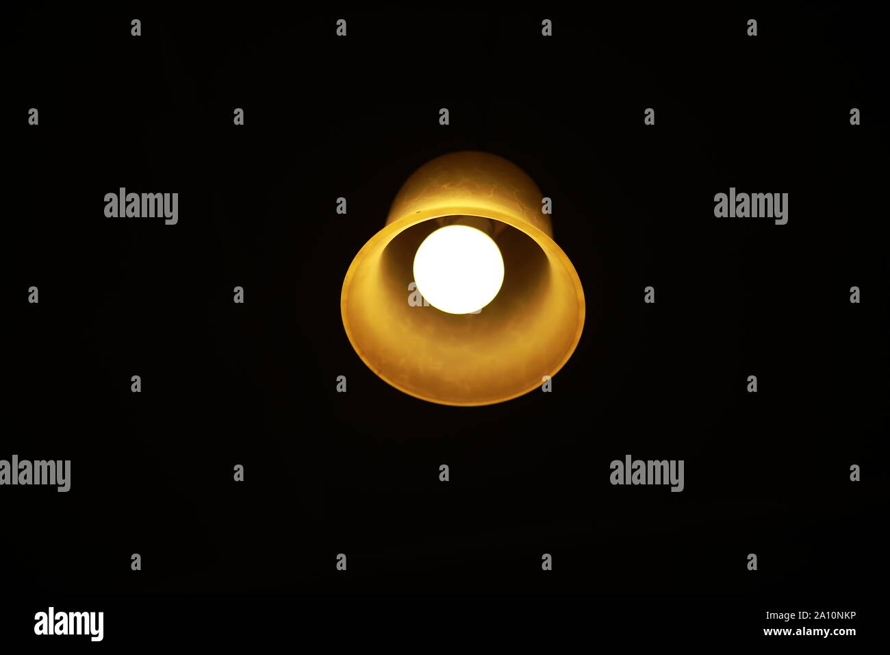 Light Bulb glowing in the darkness Stock Photo