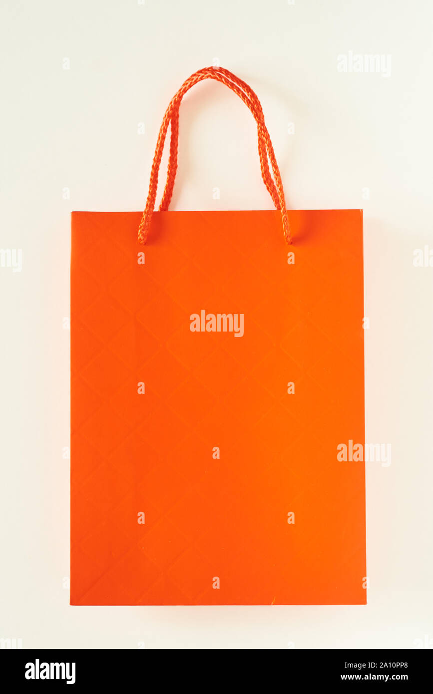 Mockup of orange paper shopping bag on white background Stock Photo - Alamy