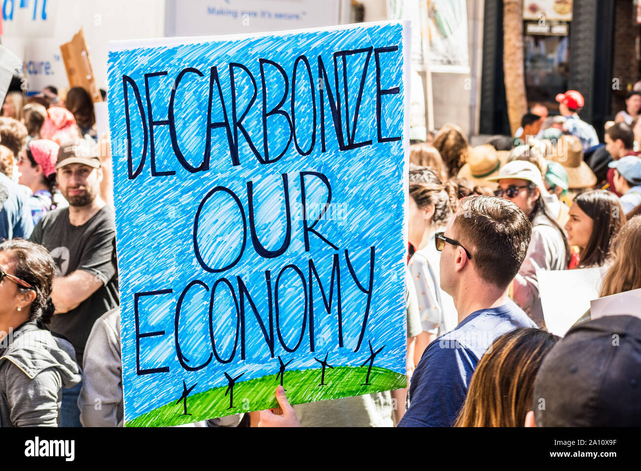 Sep 20, 2019 San Francisco / CA / USA - Decarbonize our economy placard raised at the Global Youth Climate Strike Rally and March in downtown San Fran Stock Photo