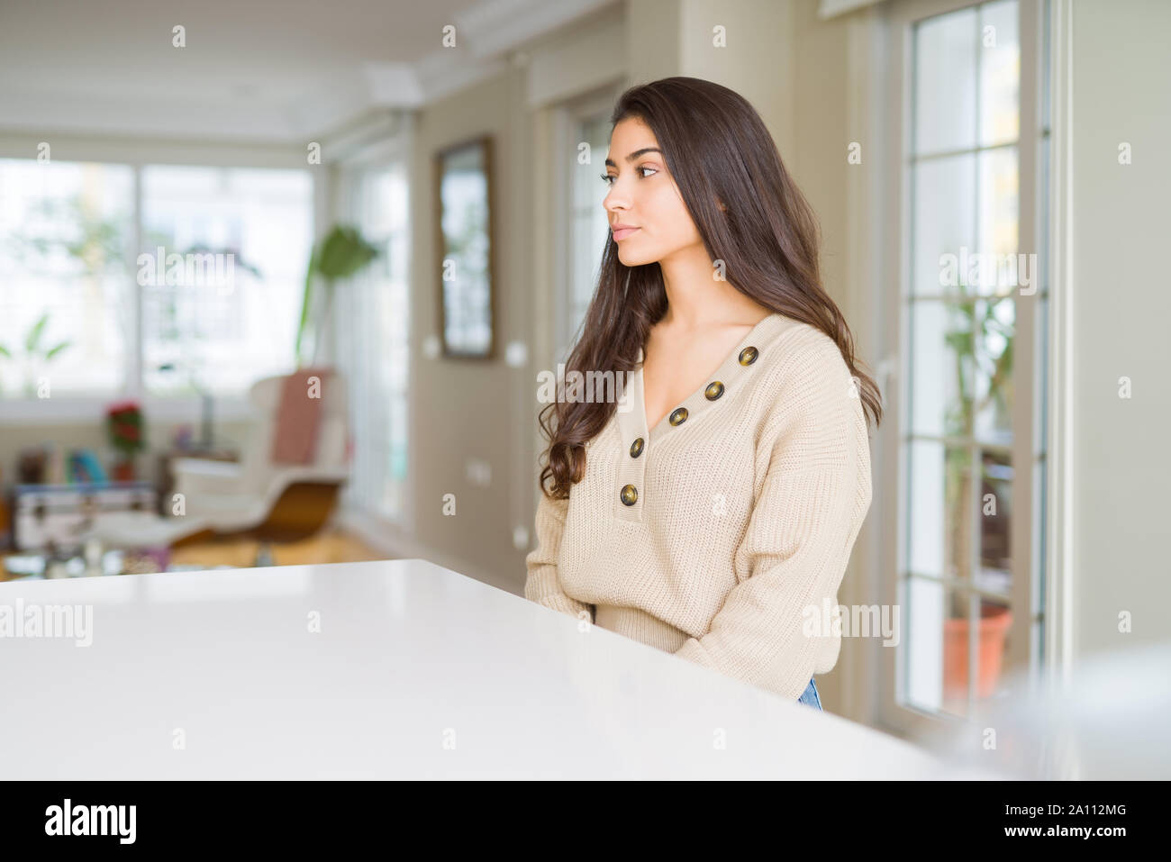 Young Beautiful Woman At Home Looking To Side Relax Profile Pose