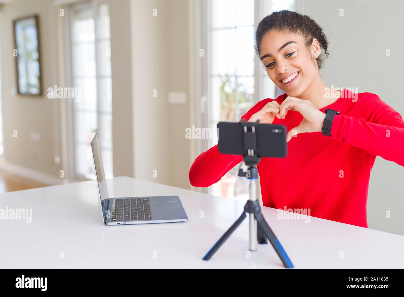 Young african american woman doing video call using smartphone camera ...