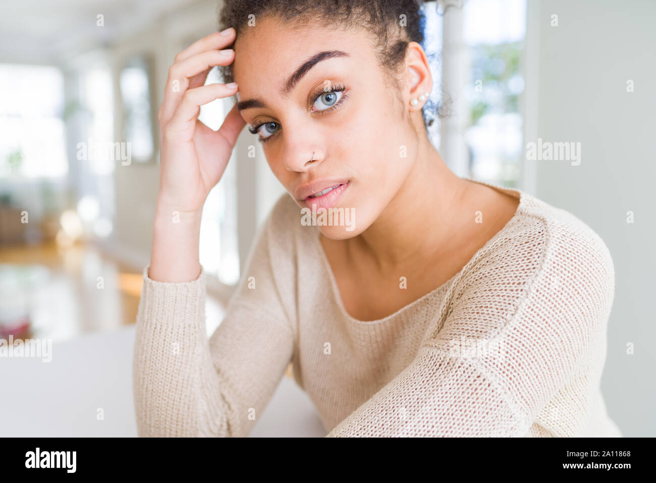 Beautiful woman with blue eyes in a black shirt on a light background Stock  Photo - Alamy