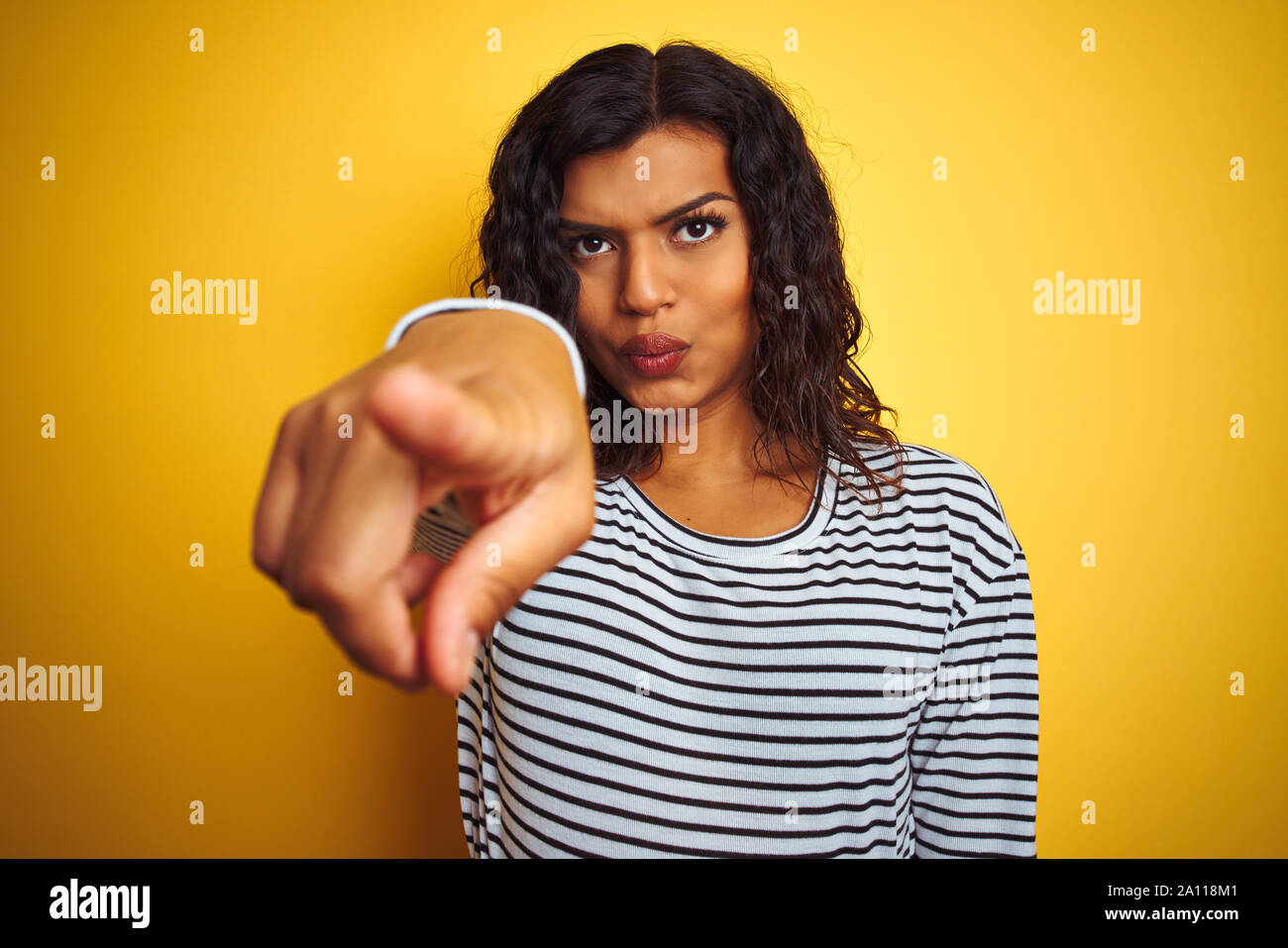 Transsexual transgender woman wearing striped t-shirt over isolated ...