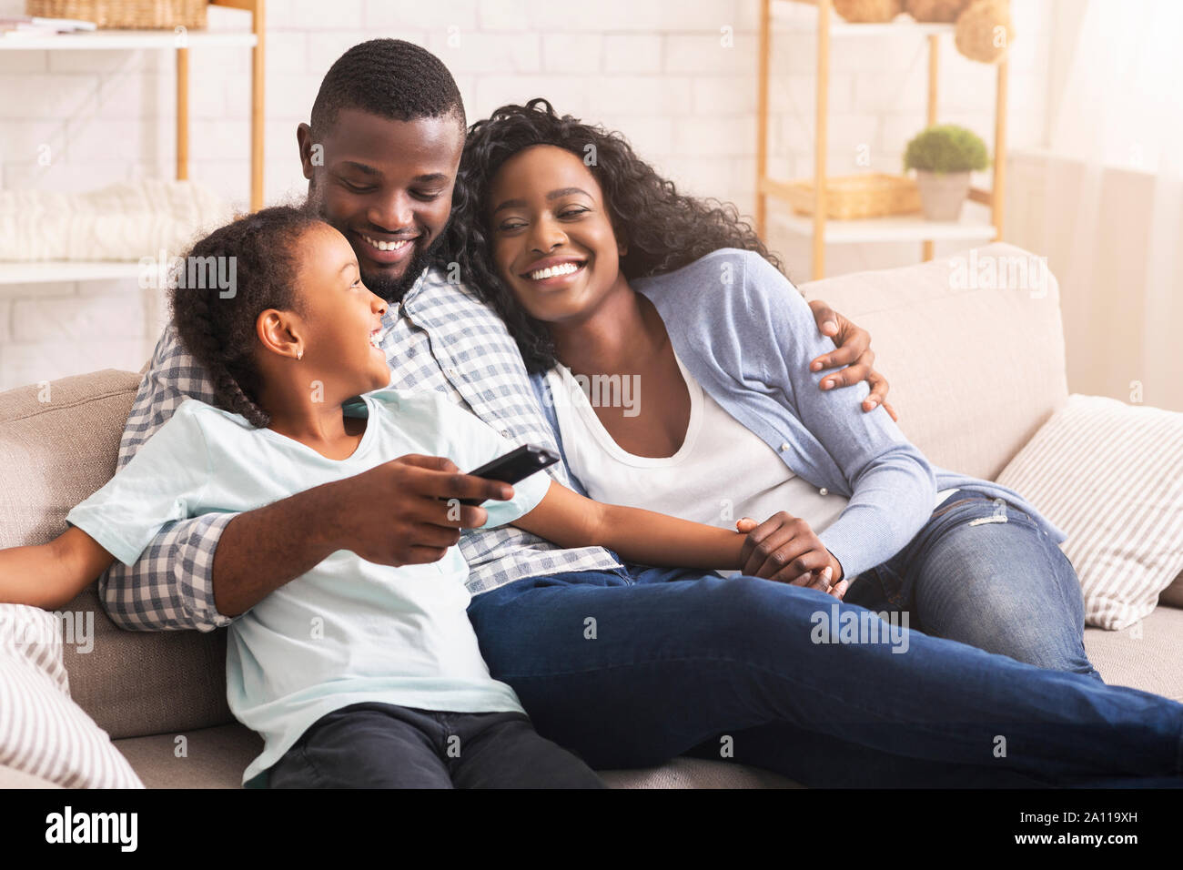 Happy african american family relaxing and watching TV at home Stock ...