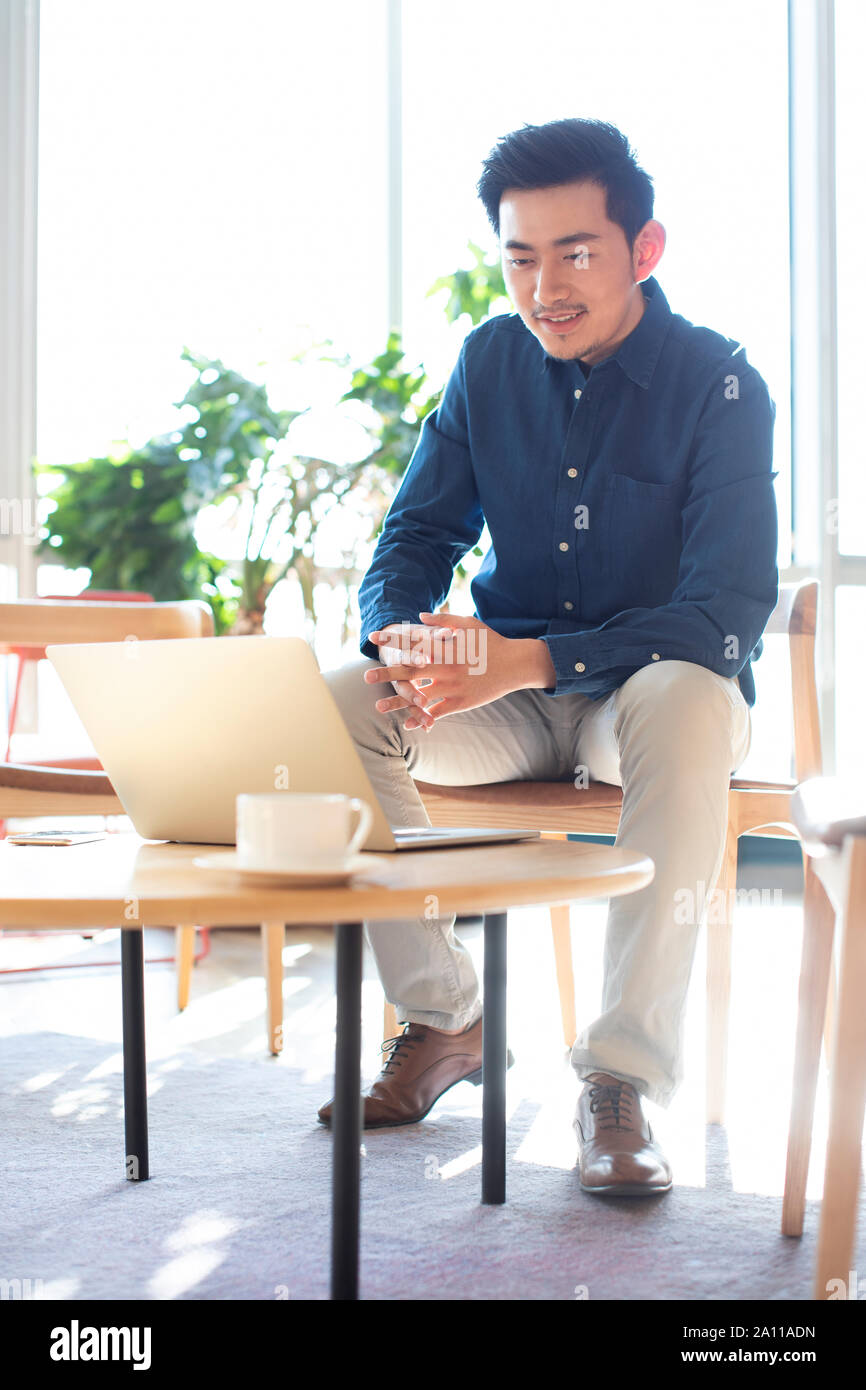 Young man using laptop Stock Photo