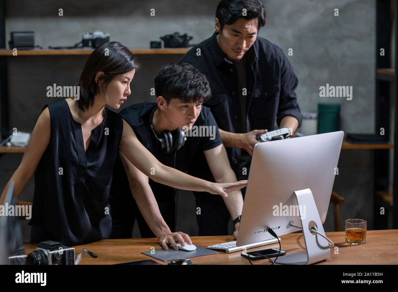 Photographers working in studio Stock Photo - Alamy