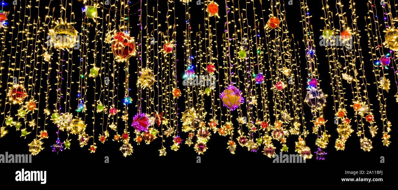 Colorful holidays garland. Christmas or New Year holydays background. Stock Photo