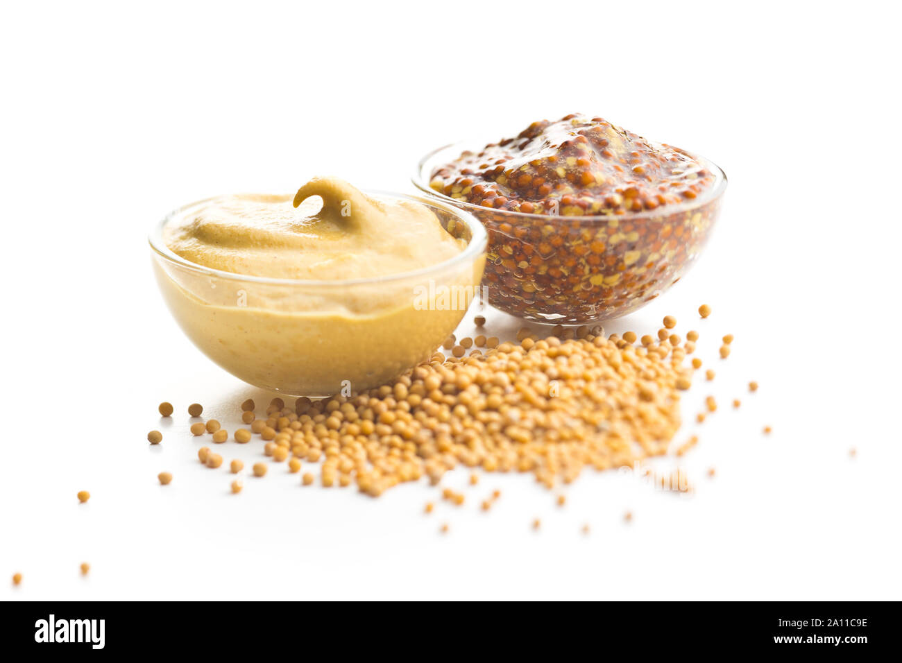 Yellow mustard and whole grain mustard isolated on white background