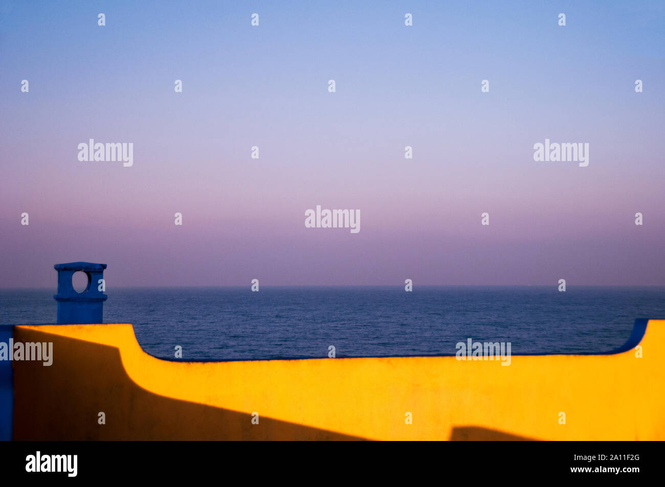Contrasting colors and a soft sunrise over the sea in Anzio, Italy. Stock Photo
