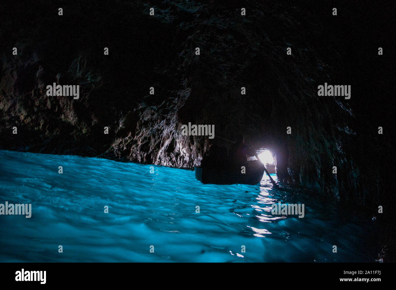 The Blue Grotto is a sea cave on the Italian island of Capri where sunlight passing through an underwater cavity creates a blue reflection inside. Stock Photo