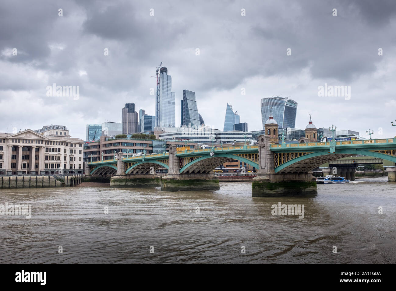 Dramatic City of London skyline with London Bridge and modern architecture Stock Photo