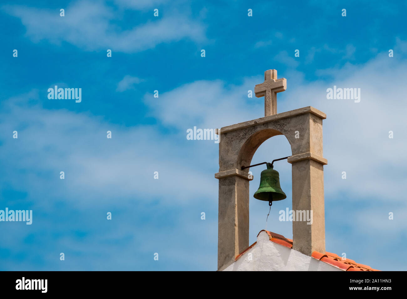 church bell and cross on church roof  - Stock Photo