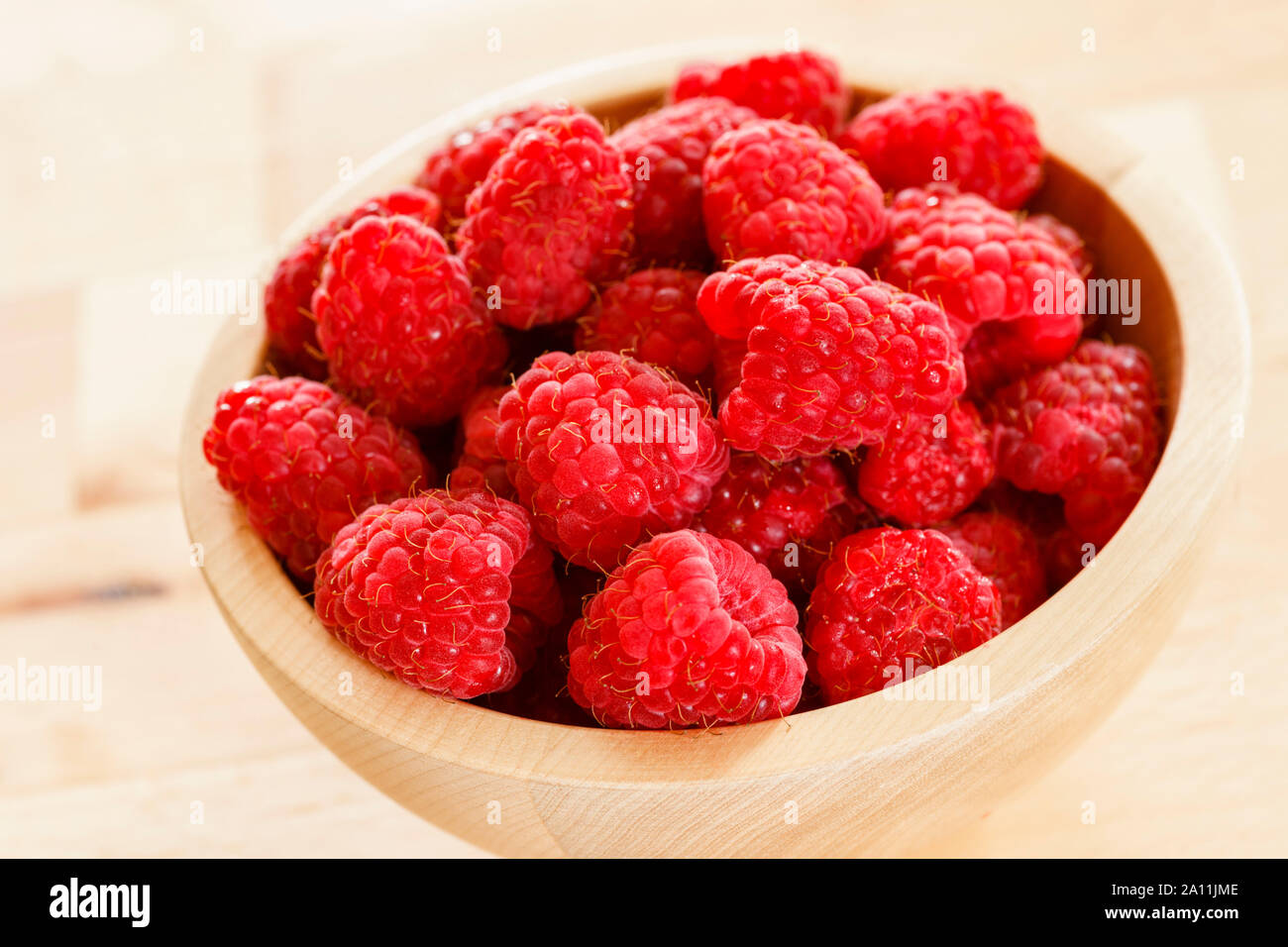 Raspberries in a bowl, close up Stock Photo