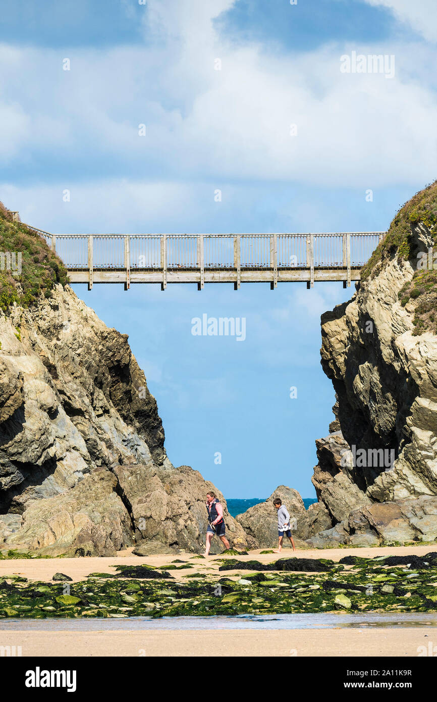 The footbridge connecting the mainland to Porth Island in Newquay in Cornwall. Stock Photo