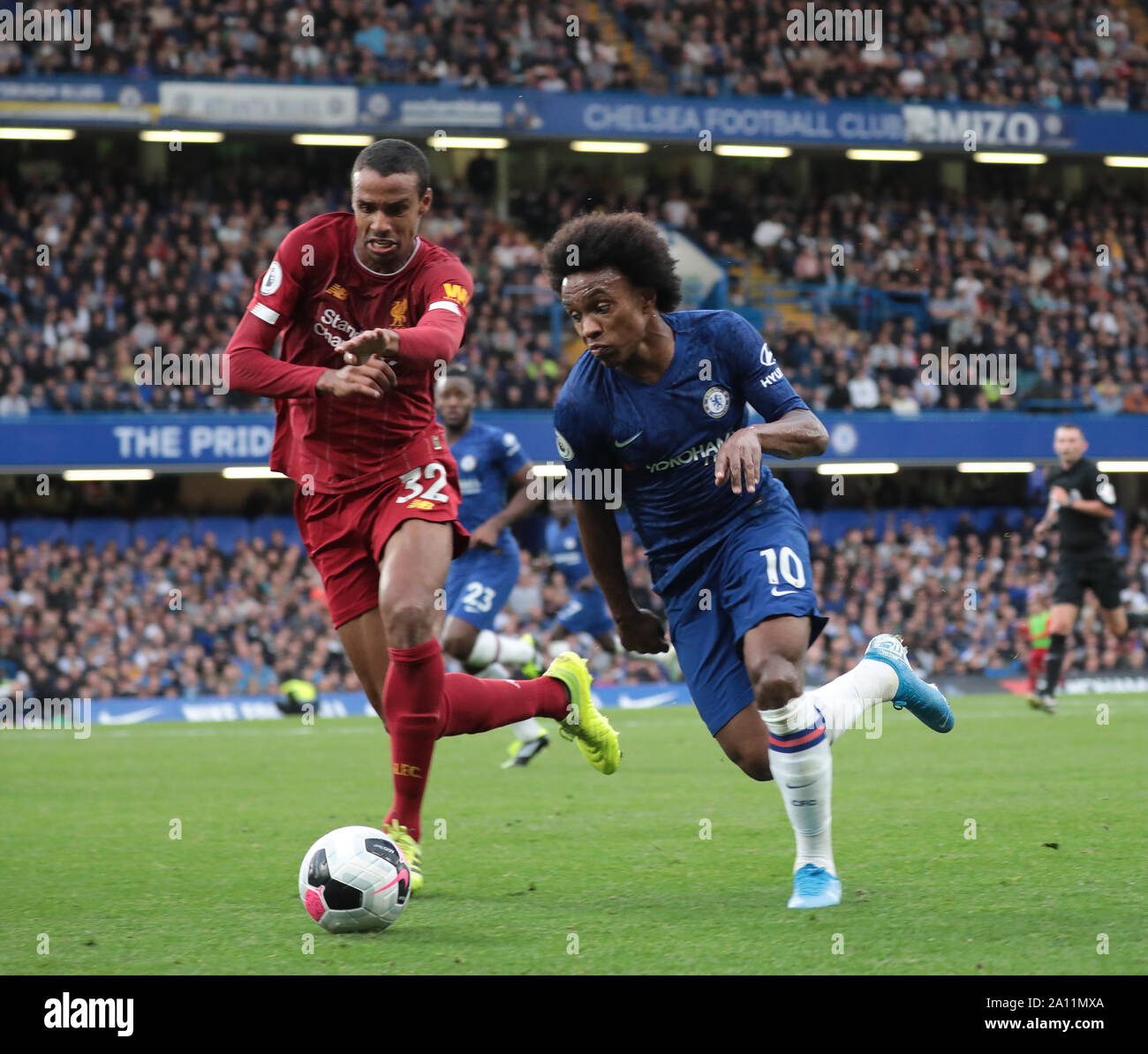 LONDON, ENGLAND - SEPTEMBER 22: Liverpool’s Joel Matip tackles Chelsea’s Willian during the Premier League match between Chelsea FC and Liverpool FC at Stamford Bridge on September 22, 2019 in London, United Kingdom. (Hugo Philpott/MB Media) Stock Photo