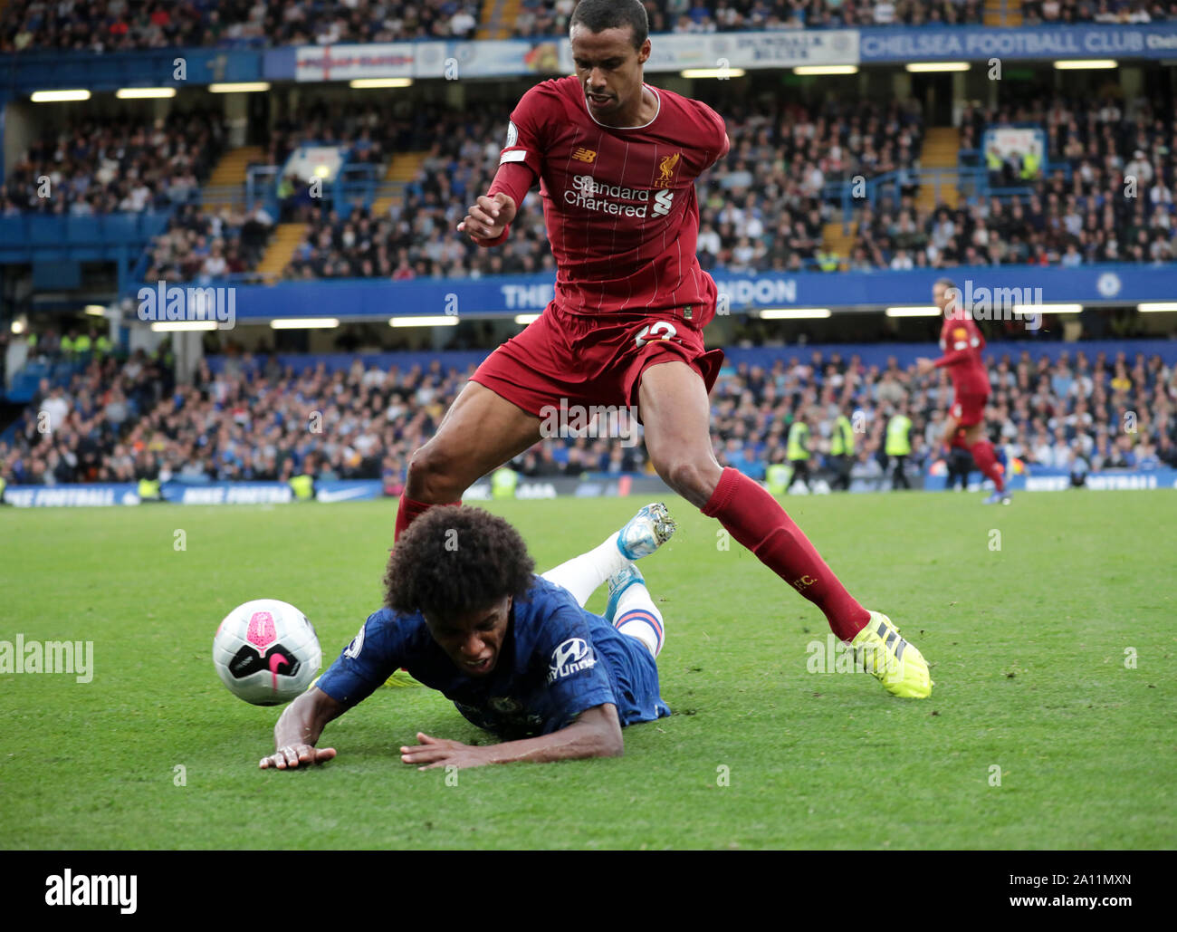 LONDON, ENGLAND - SEPTEMBER 22: Liverpool’s Joel Matip tackles Chelsea’s Willian during the Premier League match between Chelsea FC and Liverpool FC at Stamford Bridge on September 22, 2019 in London, United Kingdom. (Hugo Philpott/MB Media) Stock Photo