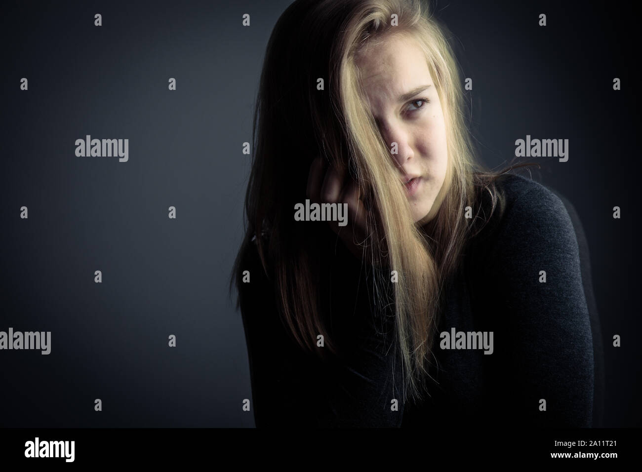 Young woman suffering from a severe stomach pain/depression/anxiety