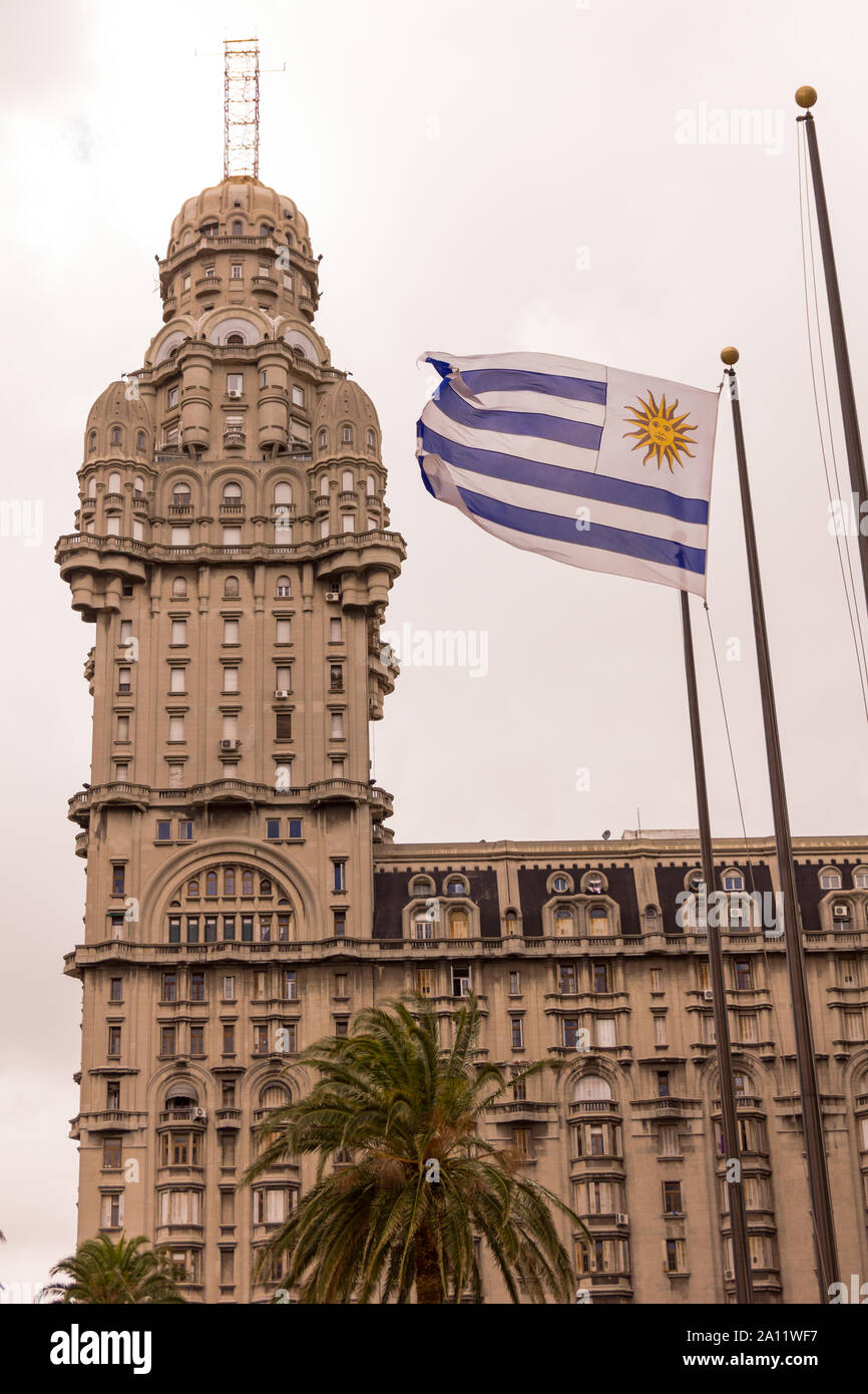 The Palacio Salvo and the Uruguayan flag, in the independence square of Montevido, the center of the capital of Uruguay, two emblems or icons of the c Stock Photo