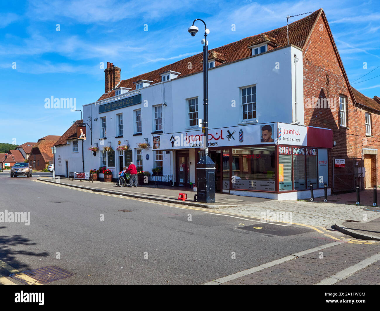 The Broadway high street in Thatcham on a quiet day in the summer with a security camera on a pole on the pavement, Thatcham, Berkshire Stock Photo