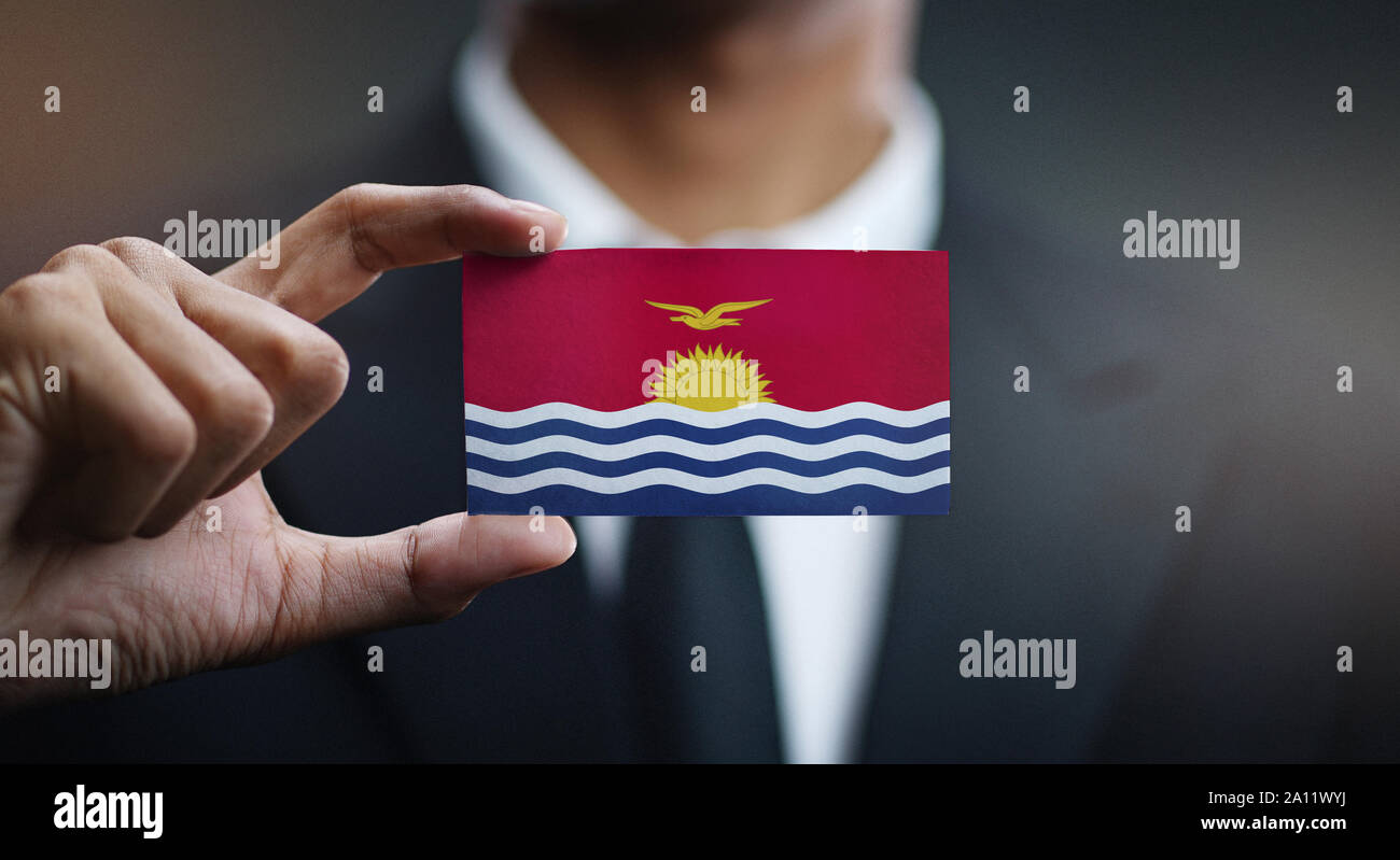 Businessman Holding Card of Kiribati Flag Stock Photo