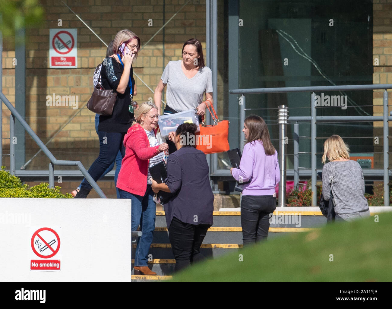 People outside the Peterborough headquarters of tour operator Thomas Cook, which has ceased trading with immediate effect after failing in a final bid to secure a rescue package from creditors. Stock Photo