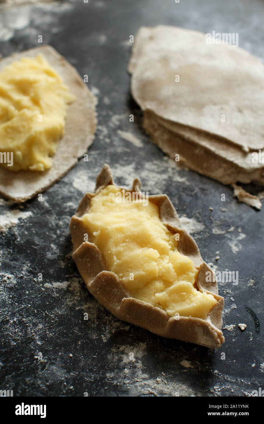 Traditional karelian pasties with potatoes before oven Stock Photo