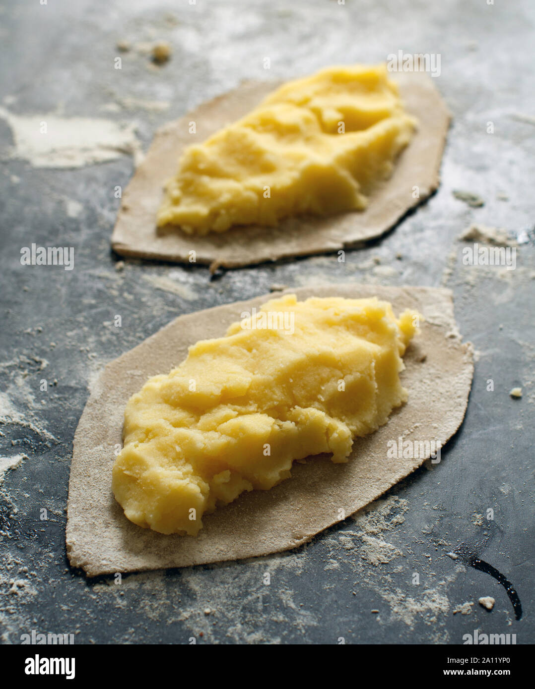 Traditional karelian pasties with potatoes before oven Stock Photo