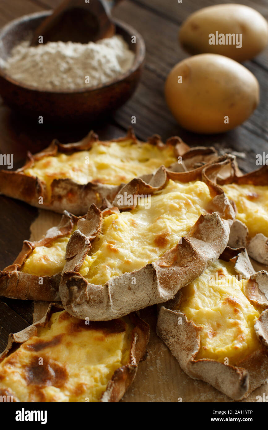 Traditional karelian pasties with  potatoes on a table Stock Photo