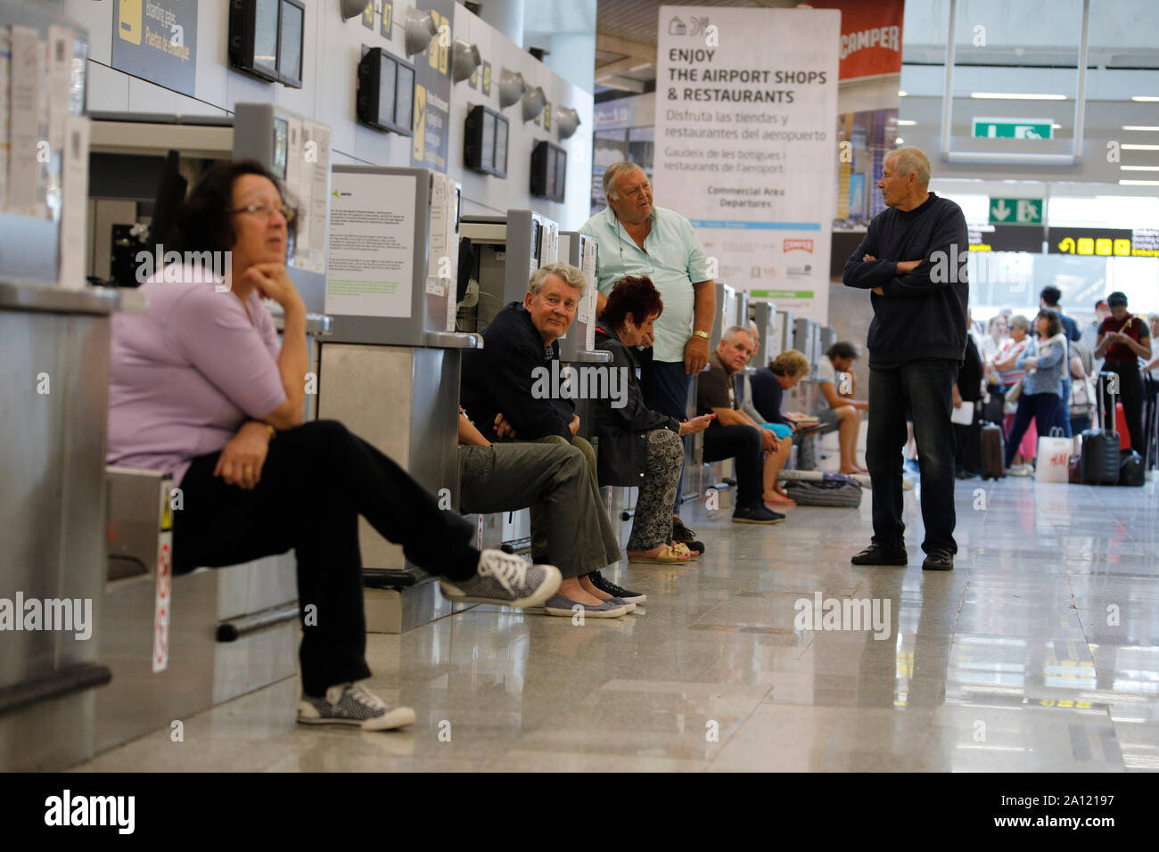 Palma, Spain. 23rd Sep, 2019. On the day of the insolvency of the British travel group Thomas Cook, passengers wait at Palma de Mallorca Airport for their onward journey. The efforts to rescue the battered British tourism group Thomas Cook have failed. The second largest travel company in Europe announced that a corresponding insolvency petition had already been filed in court. Credit: Clara Margais/dpa/Alamy Live News Stock Photo