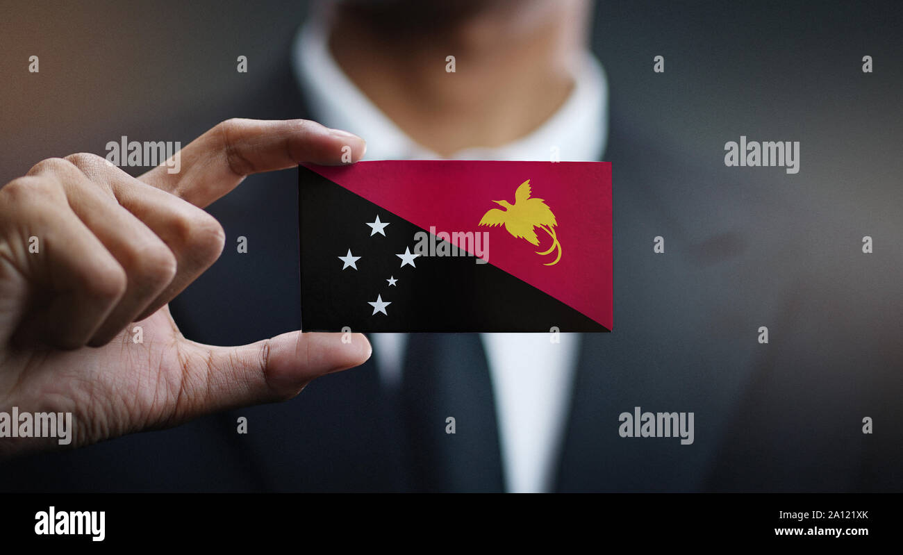 Businessman Holding Card Papua New Guinea Flag Stock Photo Alamy