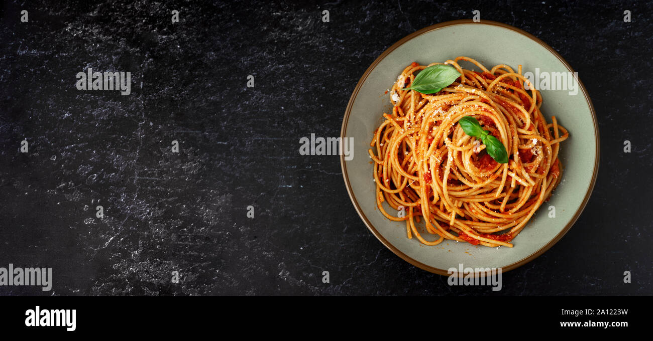 Spaghetti with tomato sauce on black background. Copy space. Banner ...