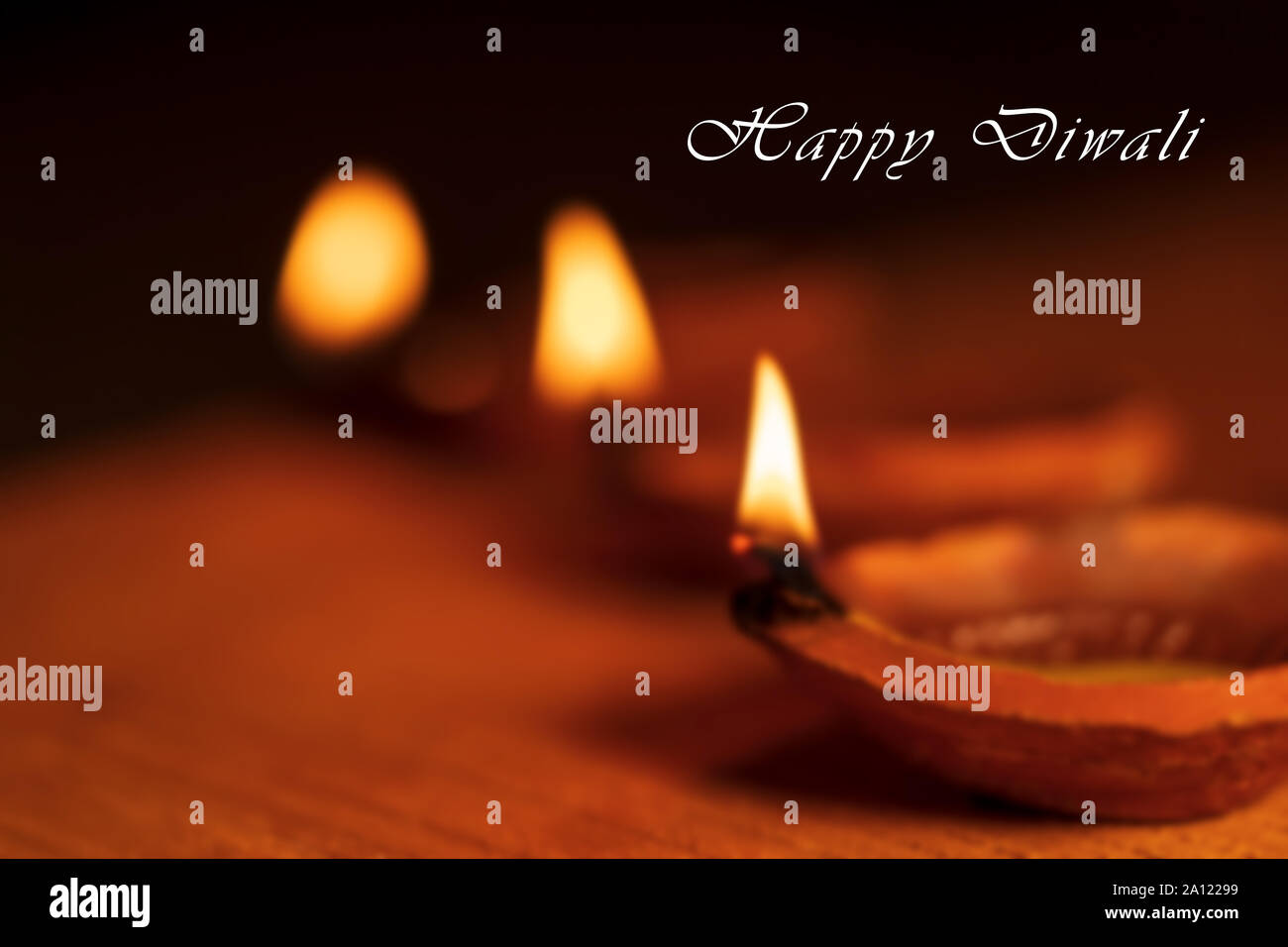 Beautiful blurred background stock photo of Diwali Diya or oil clay lamp  with Happy Diwali text and copy space isolated on black background Stock  Photo - Alamy