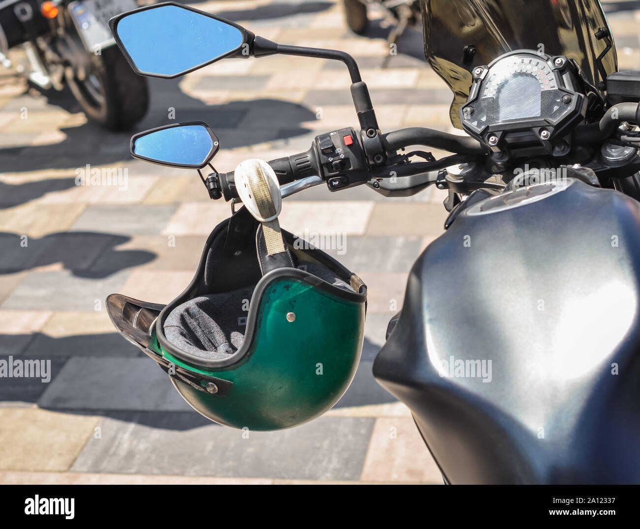 motorcycle steering wheel with dashboard and helmet closeup Stock Photo