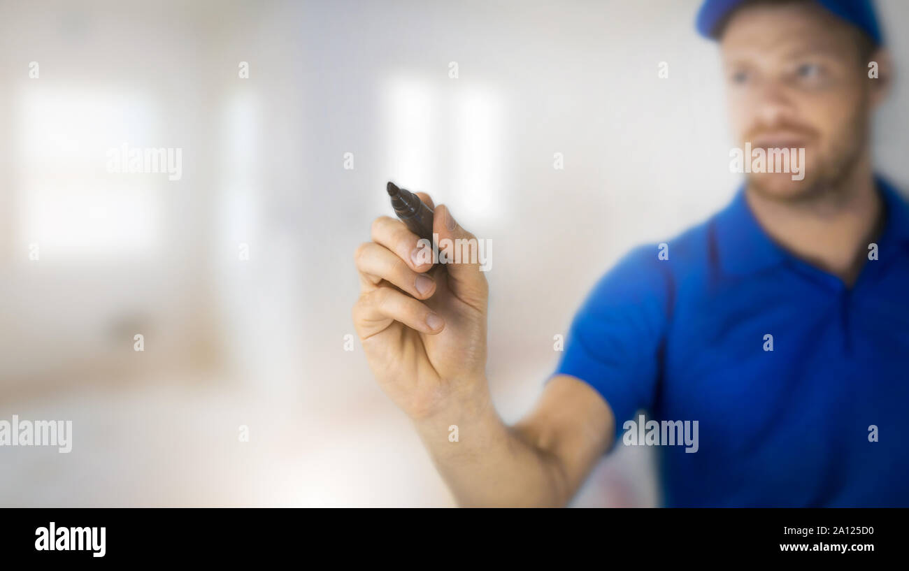 worker with black marker pen in hand with copy space Stock Photo