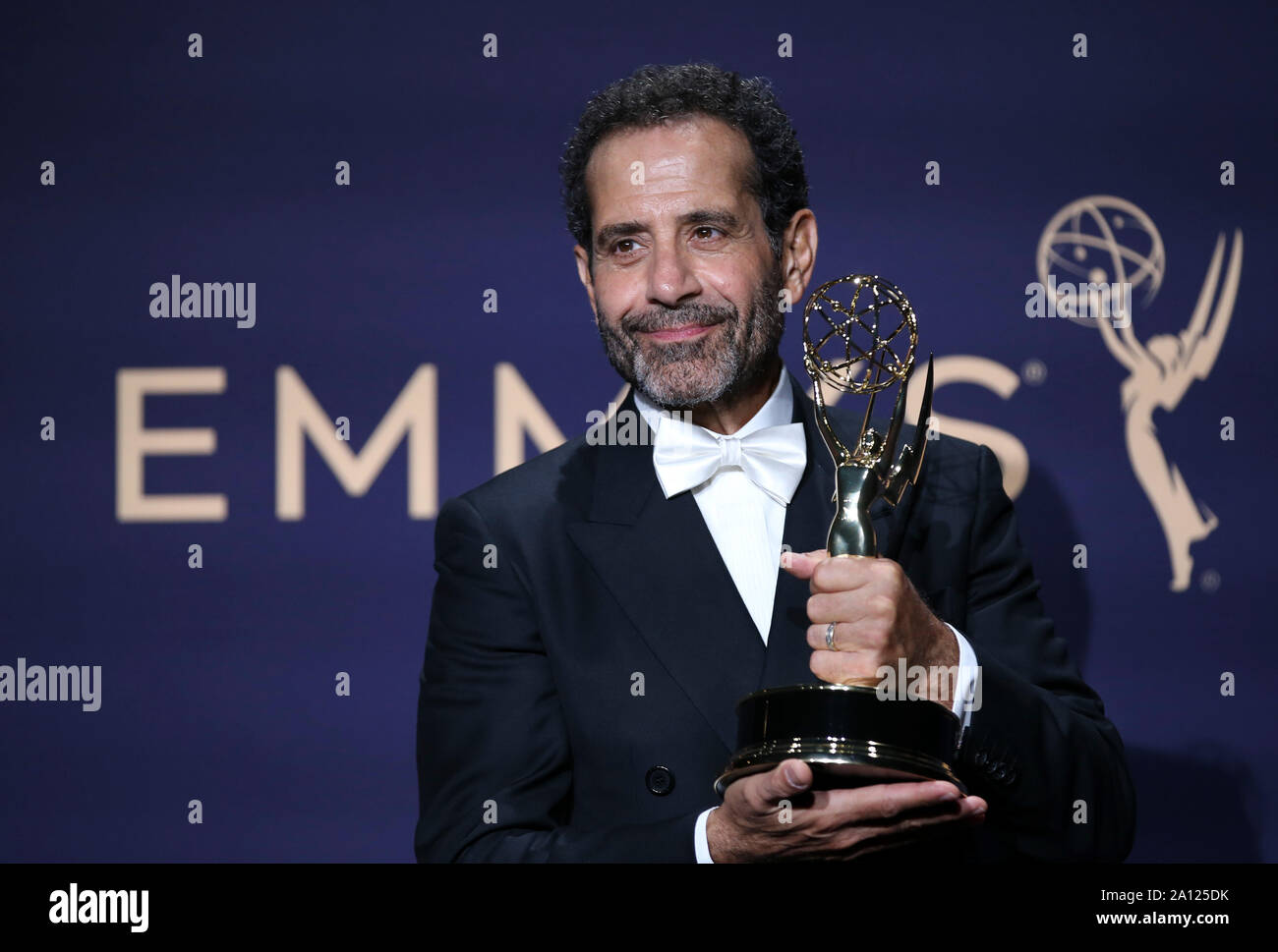 Los Angeles, USA. 22nd Sep, 2019. Actor Tony Shalhoub poses with the award for outstanding supporting actor in a comedy series for 'The Marvelous Mrs. Maisel' during the 71st Primetime Emmy Awards in Los Angeles, the United States, Sept. 22, 2019. Credit: Li Ying/Xinhua/Alamy Live News Stock Photo