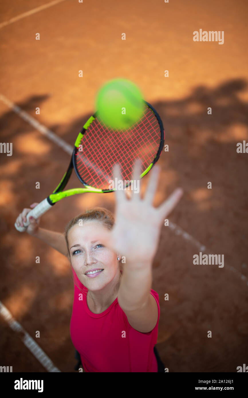 Feeling confident on tennis court.Top view of attractive young woman tennis  player serving on a clay tennis court. Interesting POV shot - sporty girl  Stock Photo - Alamy
