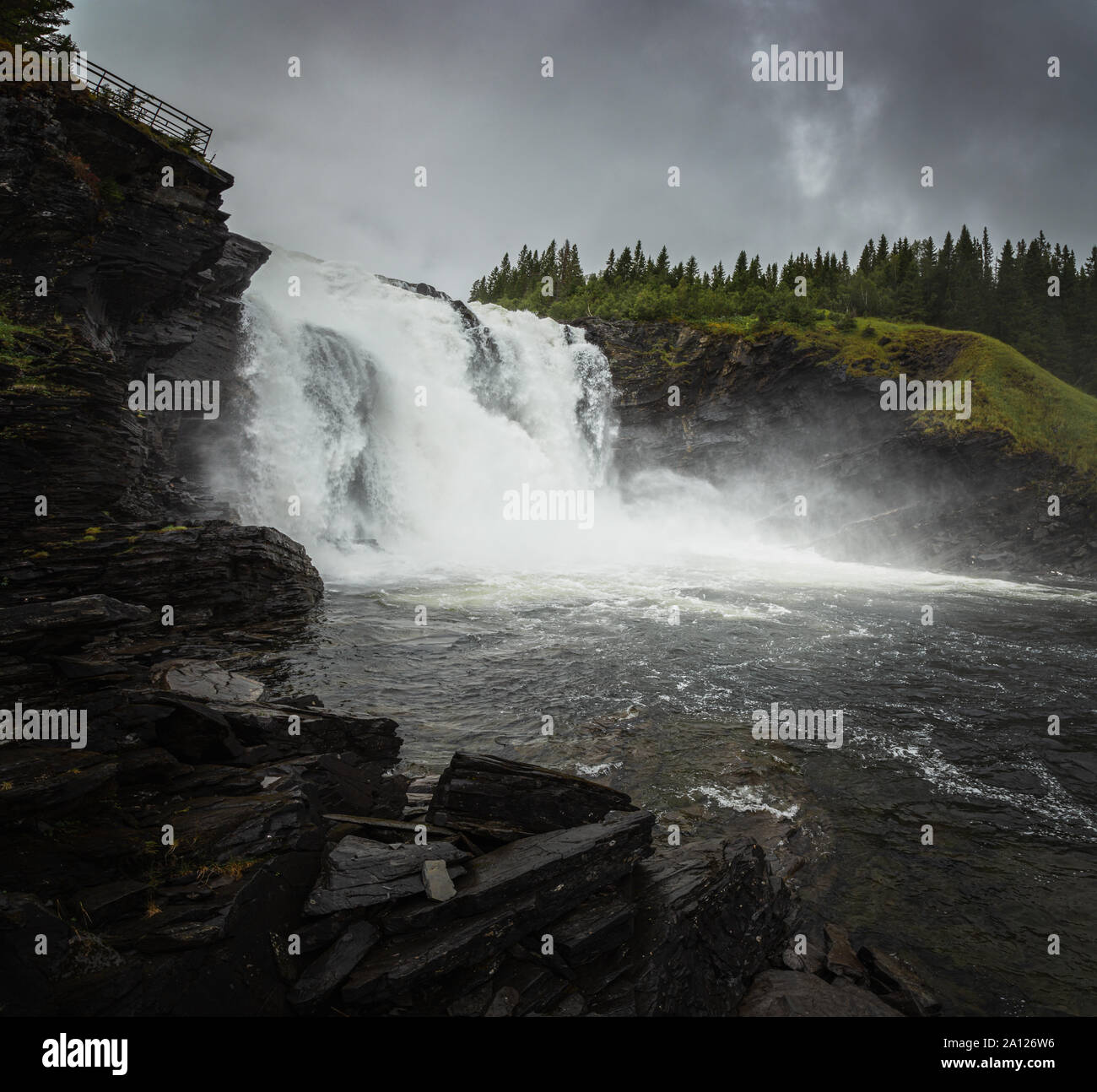 The biggest waterfall of Sweden. High water level of the river after big rain falls. Swedish powerful nature. Stock Photo