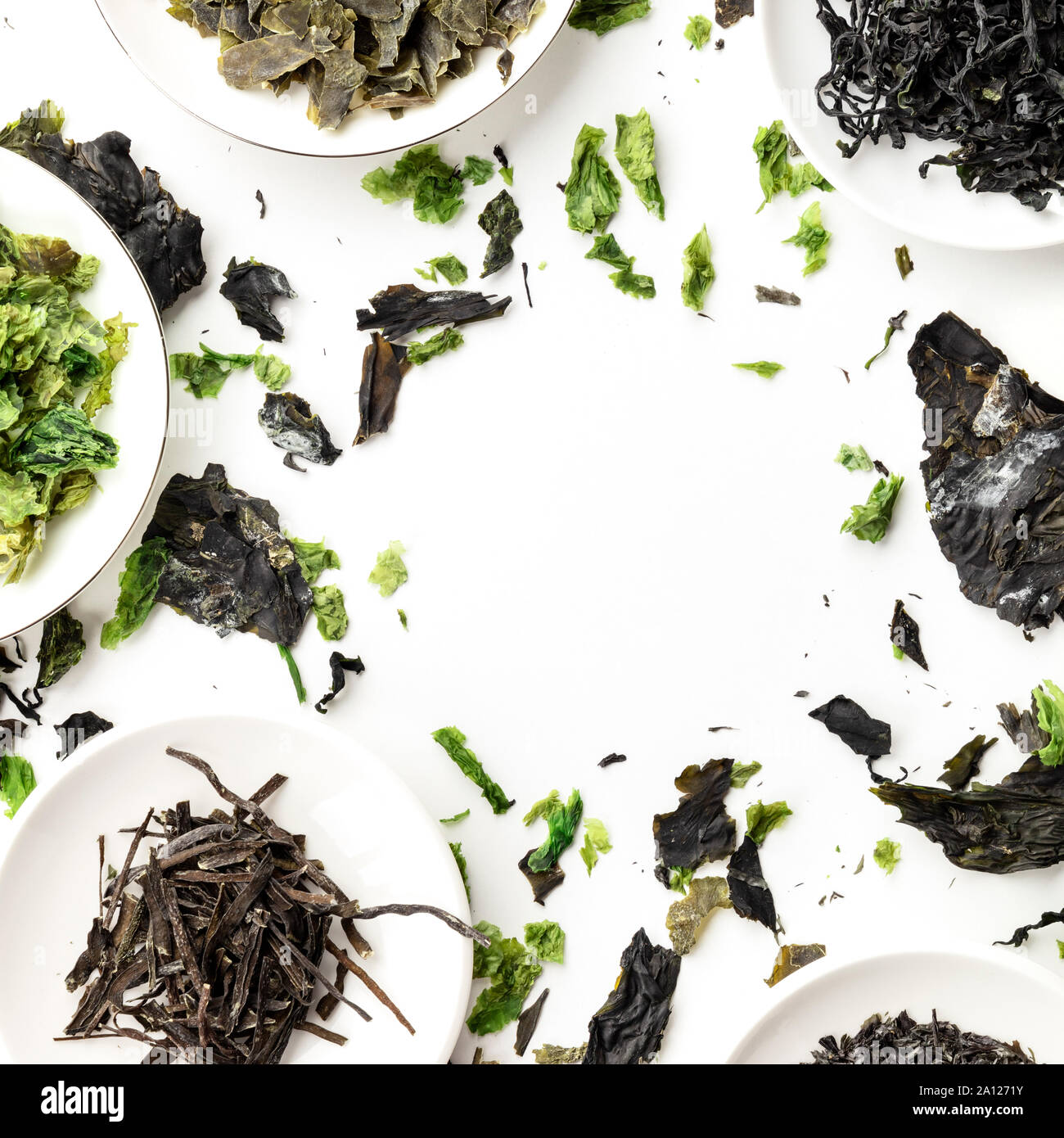Dry seaweed, sea vegetables, overhead square shot on a white background, forming a frame. A design template with copy space Stock Photo