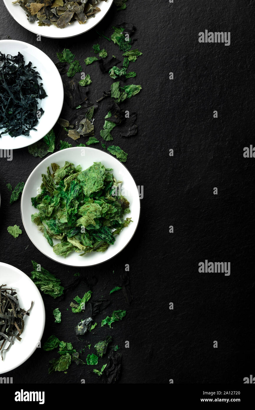 Various dry seaweed, sea vegetables, shot from above on a black background with copy space Stock Photo