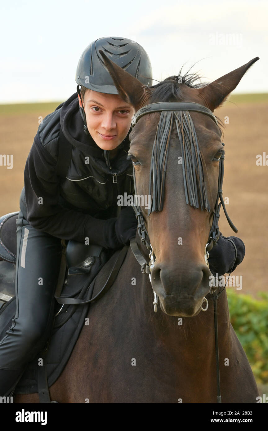 Teenage boy with a horse in nature Stock Photo