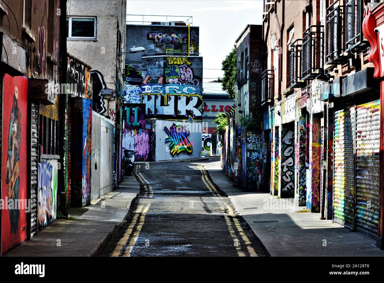 An alley in a main street in Dublin full of graffiti art work Stock