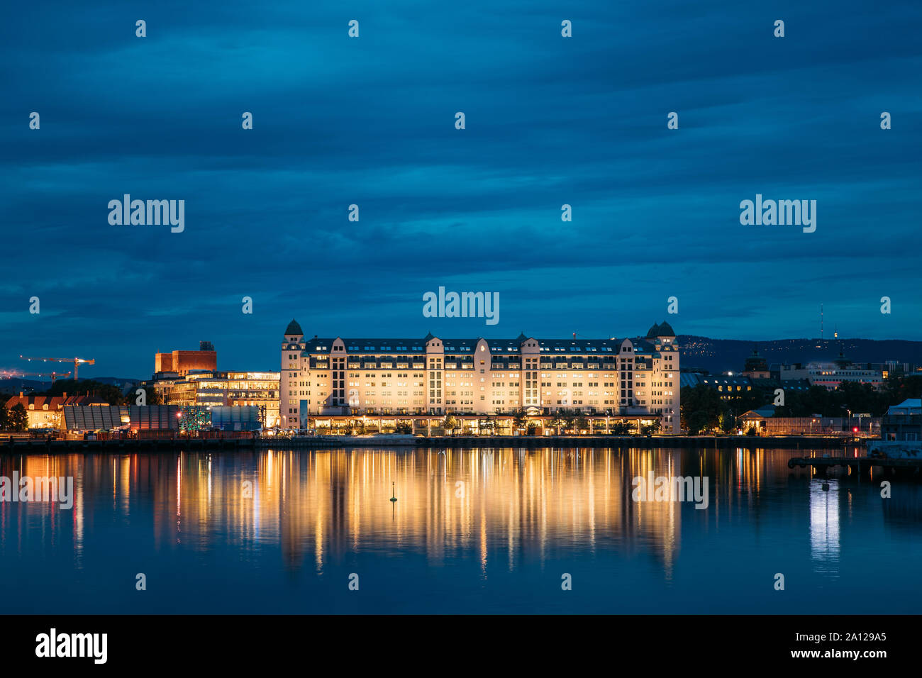 Oslo, Norway. Night View Embankment And Residential Multi-storey House On Langkaia Street In City Center In Oslo, Norway. Summer Evening. Residential Stock Photo
