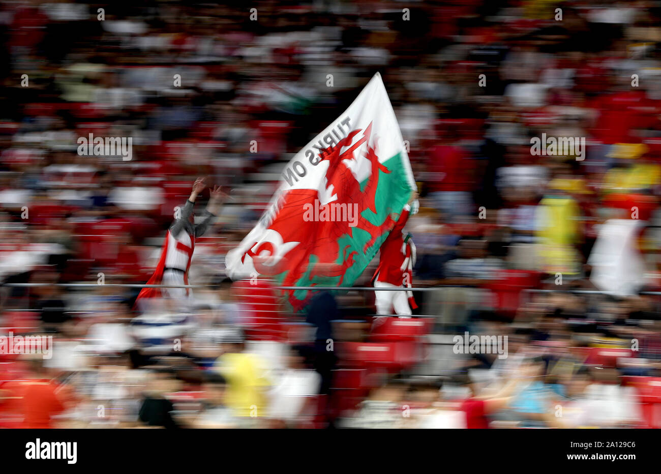 Fans of Wales show their support in the stands with a flag of Wales ...