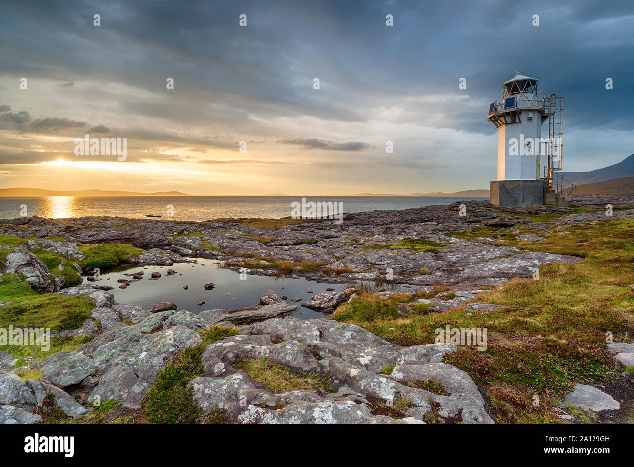 Sunset at Rhue lighthouse near Ullapool in the far north west of Scotland Stock Photo