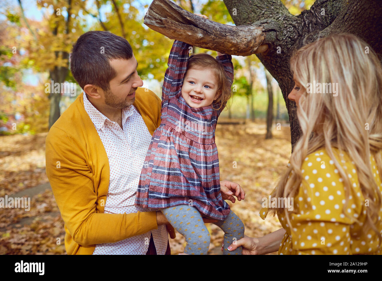 Happy family playing in the park in the fall Stock Photo - Alamy